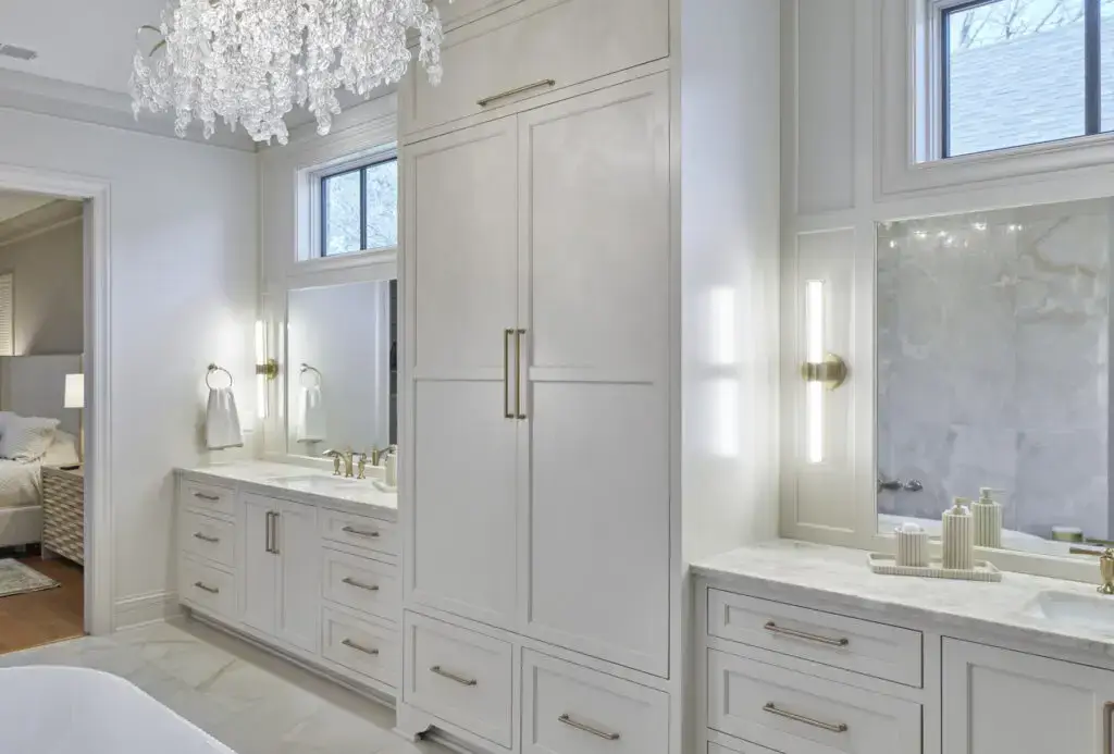 white cabinets in master bathroom with two sinks